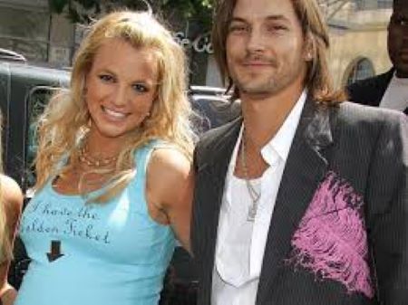 A man and woman strike a pose on a red carpet, radiating elegance and style in their chic attire amidst a glamorous setting.